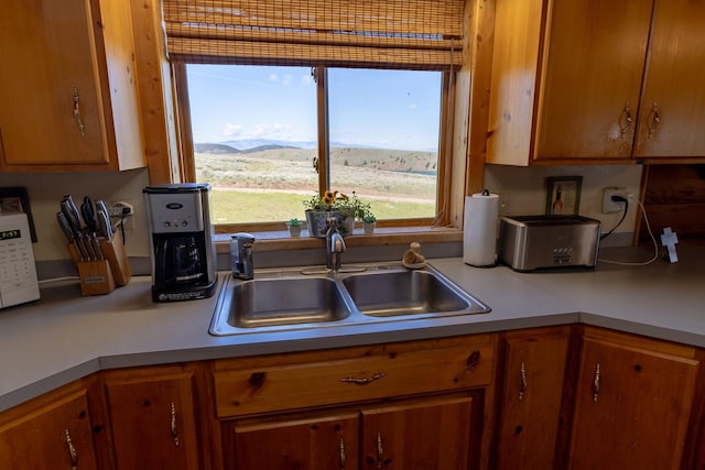 347 Upper Ross Gulch Rd, Townsend, MT 59644 - kitchen featuring light countertops, brown cabinetry, and a mountain view