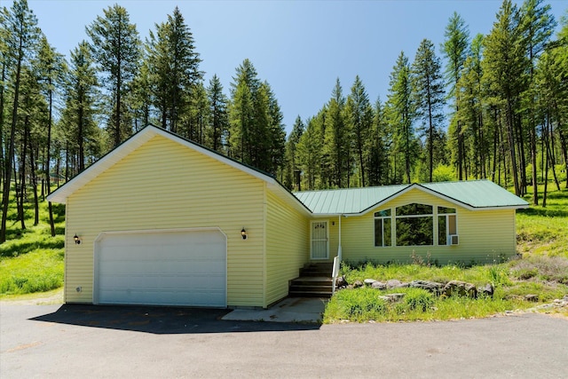 42843 Jette Lake Trl, Polson, MT 59860 - view of front facade featuring a garage and metal roof
