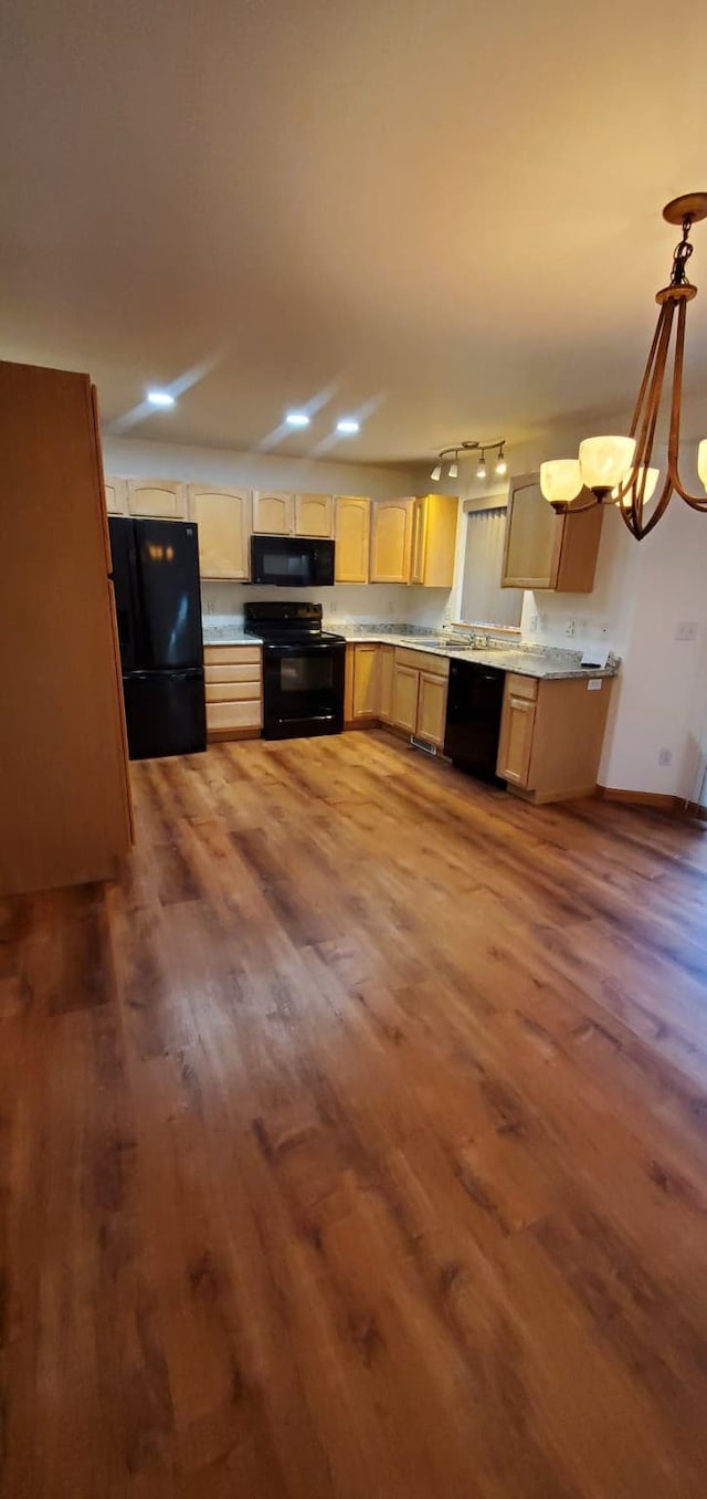 42843 Jette Lake Trl, Polson, MT 59860 - kitchen featuring black appliances, wood finished floors, light countertops, a chandelier, and rail lighting