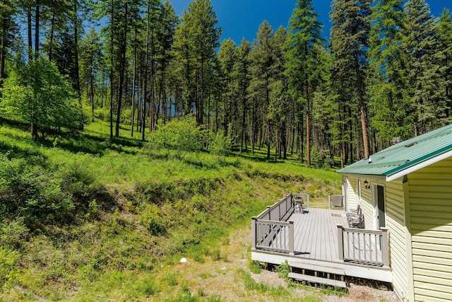 42843 Jette Lake Trl, Polson, MT 59860 - view of yard featuring a deck and a view of trees