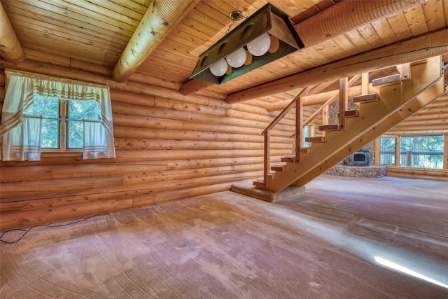 1795 E Fork Rd, Sula, MT 59871 - unfurnished living room with rustic walls, wooden ceiling with exposed beams, carpet flooring, and stairway