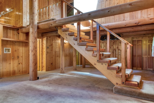 1795 E Fork Rd, Sula, MT 59871 - stairway with wooden walls, a high ceiling, and carpet flooring