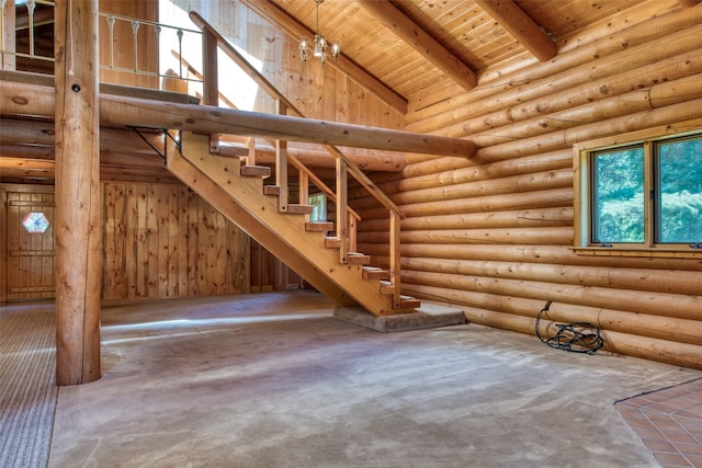 1795 E Fork Rd, Sula, MT 59871 - unfurnished living room featuring wood ceiling with exposed beams, carpet, stairway, and a towering ceiling