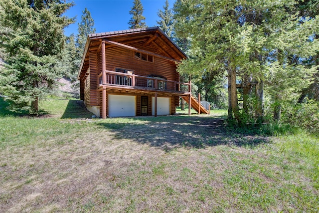 1795 E Fork Rd, Sula, MT 59871 - back of property with log exterior, stairs, a garage, a wooden deck, and metal roof