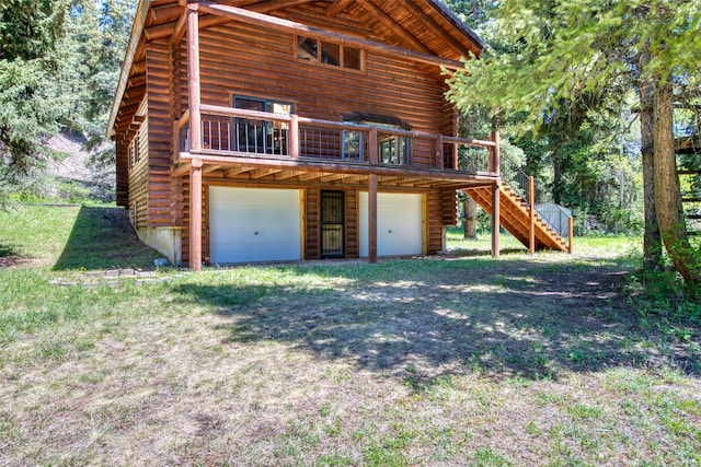 1795 E Fork Rd, Sula, MT 59871 - back of property featuring log siding, a garage, stairway, and a deck