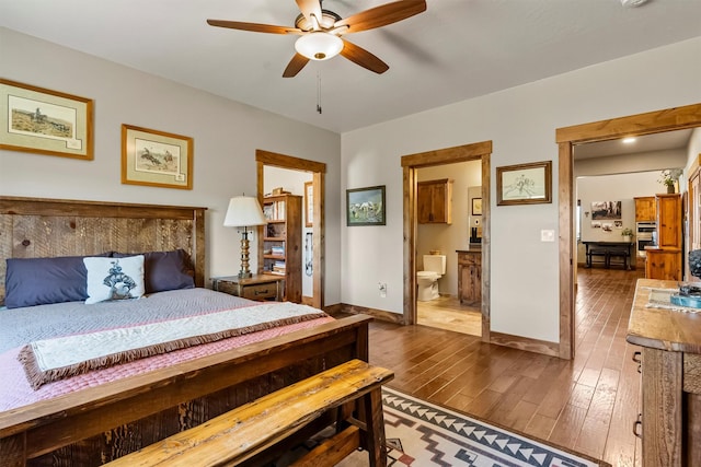 144 Prickly Pear Ct, Florence, MT 59833 - bedroom with dark wood finished floors, ensuite bath, and a ceiling fan