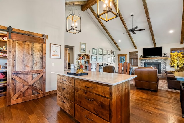144 Prickly Pear Ct, Florence, MT 59833 - kitchen with a ceiling fan, dark wood-type flooring, beamed ceiling, high vaulted ceiling, and a center island