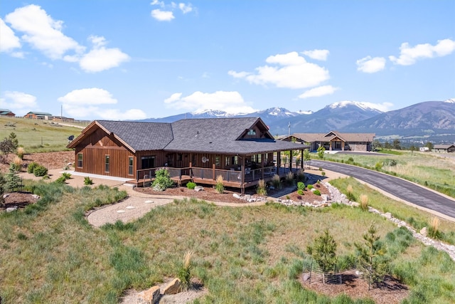144 Prickly Pear Ct, Florence, MT 59833 - view of front of home with a shingled roof and a deck with mountain view