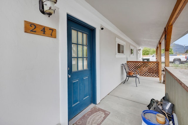 245 Marcus St, Hamilton, MT 59840 - property entrance featuring stucco siding and covered porch