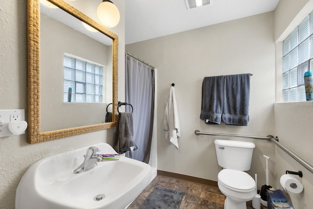 245 Marcus St, Hamilton, MT 59840 - full bathroom featuring stone finish floors and a shower with curtain