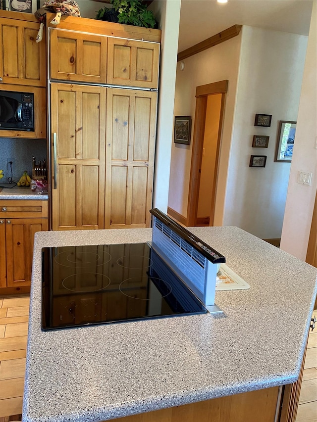 50-60 Willow Bend Ln, Cascade, MT 59421 - kitchen featuring black appliances, brown cabinetry, light stone countertops, and crown molding