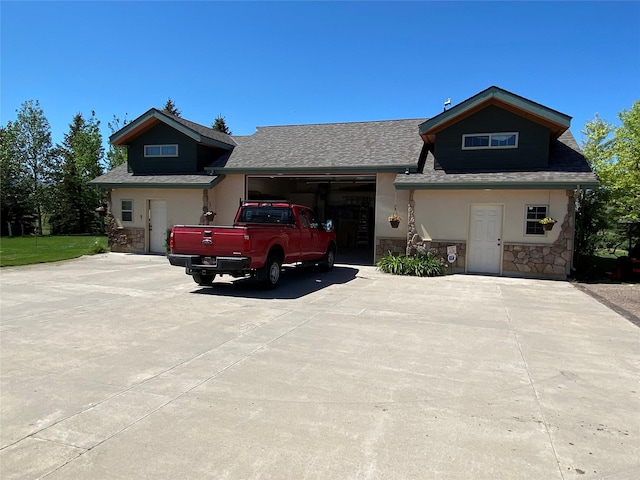 50-60 Willow Bend Ln, Cascade, MT 59421 - view of front facade with stone siding, an attached garage, driveway, a shingled roof, and stucco siding