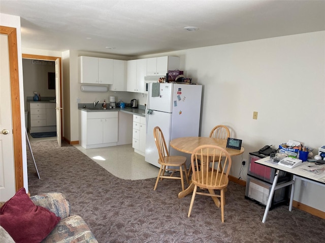 50-60 Willow Bend Ln, Cascade, MT 59421 - kitchen with freestanding refrigerator, white cabinetry, a sink, and baseboards