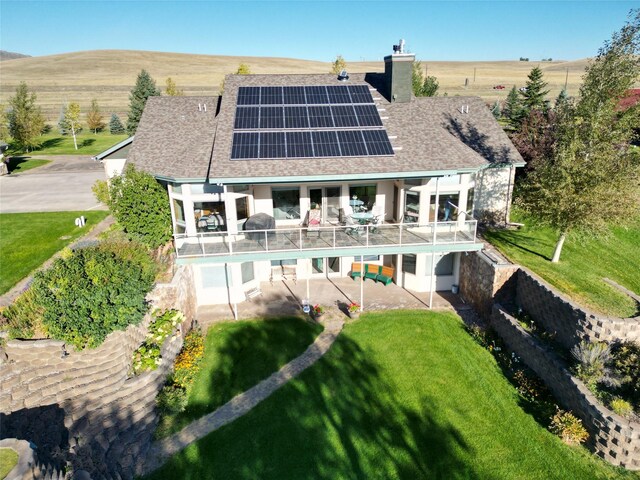 50-60 Willow Bend Ln, Cascade, MT 59421 - rear view of property with a chimney, solar panels, a shingled roof, a patio area, and a lawn