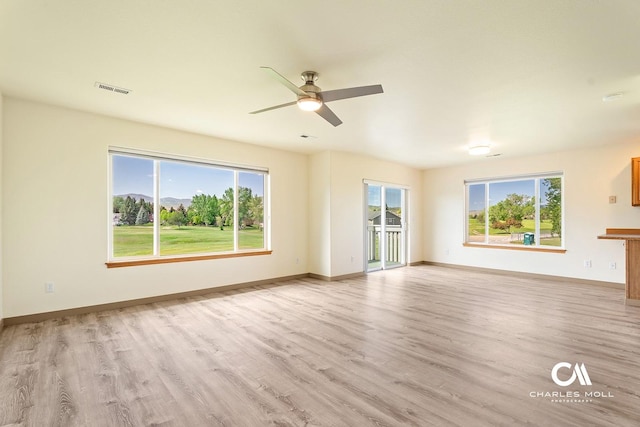 3036 Mchugh Ln, Helena, MT 59601 - unfurnished living room with light wood finished floors, a ceiling fan, and plenty of natural light