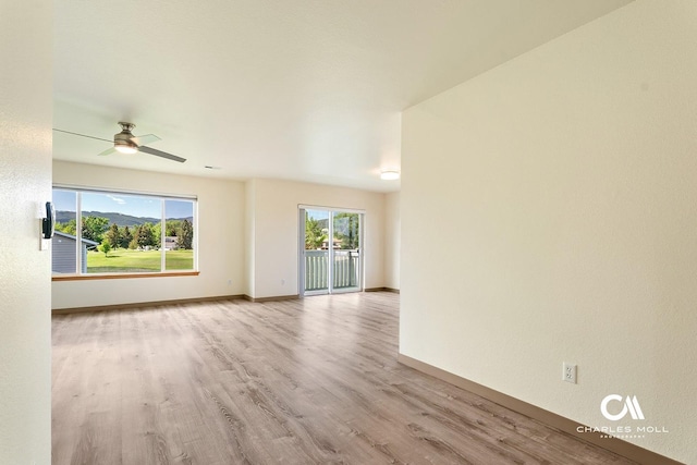 3036 Mchugh Ln, Helena, MT 59601 - unfurnished living room with wood finished floors, healthy amount of natural light, and ceiling fan