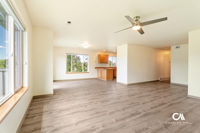 3036 Mchugh Ln, Helena, MT 59601 - unfurnished living room with light wood-type flooring and ceiling fan