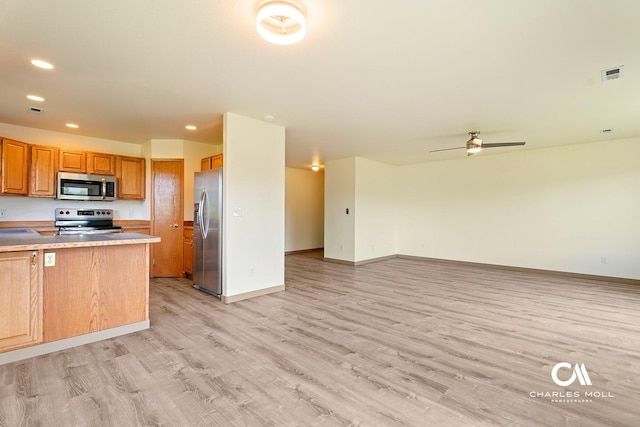 3036 Mchugh Ln, Helena, MT 59601 - kitchen with stainless steel appliances, open floor plan, light wood-style floors, recessed lighting, and ceiling fan