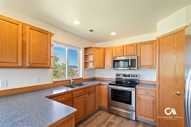 3036 Mchugh Ln, Helena, MT 59601 - kitchen featuring appliances with stainless steel finishes, recessed lighting, open shelves, brown cabinetry, and light wood finished floors
