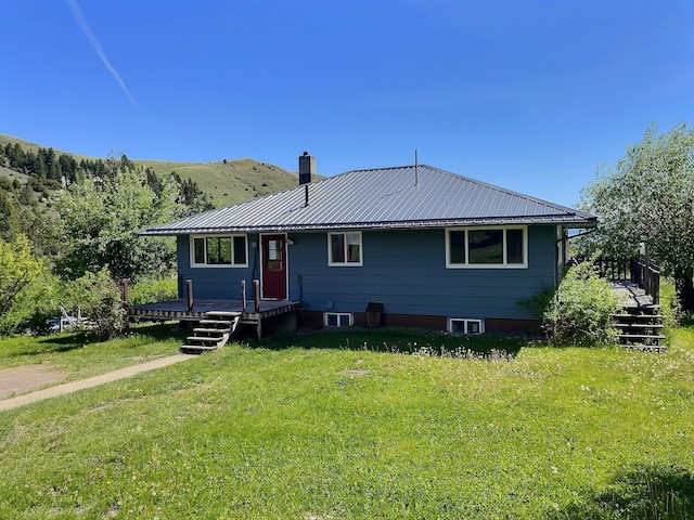 109 Edwards Gulch Rd, Drummond, MT 59832 - view of front of house featuring a front yard, a chimney, a wooden deck, stairs, and metal roof