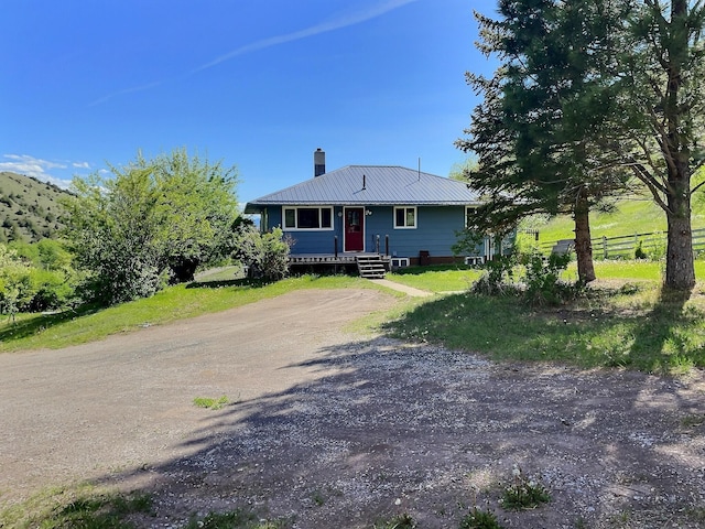 109 Edwards Gulch Rd, Drummond, MT 59832 - bungalow-style house featuring a chimney, metal roof, and dirt driveway