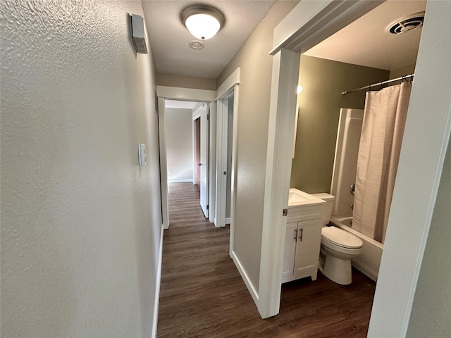 1112 Cannon St, Helena, MT 59601 - full bathroom with wood finished floors, toilet, vanity, shower / bathtub combination with curtain, and baseboards