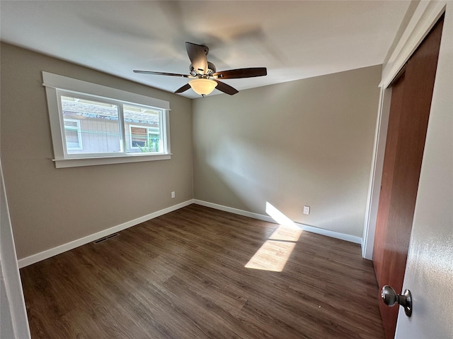 1112 Cannon St, Helena, MT 59601 - unfurnished bedroom featuring a closet, baseboards, dark wood finished floors, and a ceiling fan