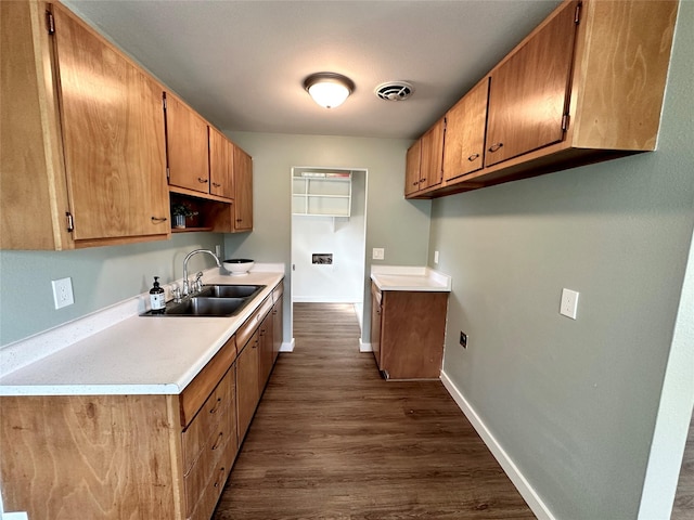 1112 Cannon St, Helena, MT 59601 - kitchen featuring a sink, dark wood-style flooring, light countertops, baseboards, and brown cabinetry