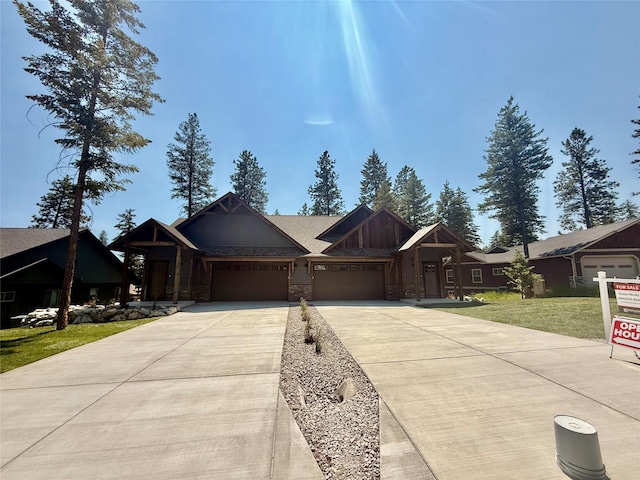 595 Grayling Rd, Lakeside, MT 59922 - view of front of home featuring an attached garage, concrete driveway, and a front yard