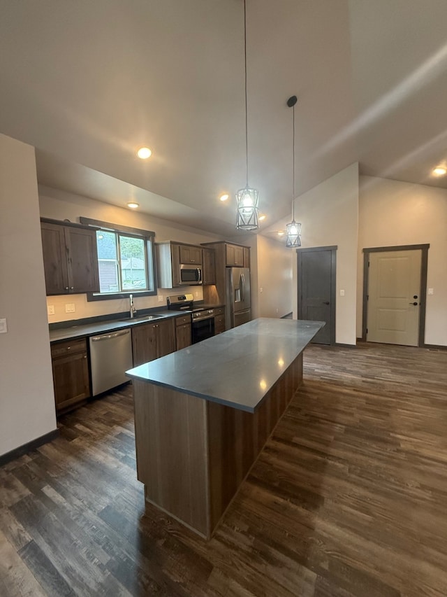 595 Grayling Rd, Lakeside, MT 59922 - kitchen with appliances with stainless steel finishes, dark countertops, dark wood-style flooring, vaulted ceiling, and recessed lighting
