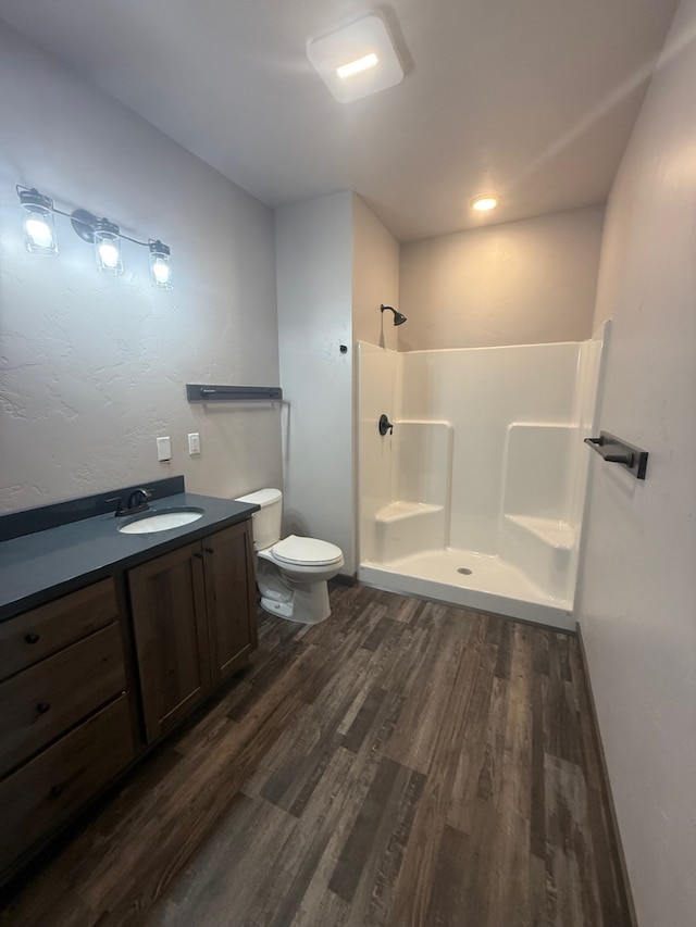 595 Grayling Rd, Lakeside, MT 59922 - bathroom featuring wood finished floors, a walk in shower, and vanity