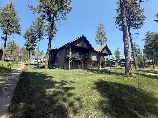 595 Grayling Rd, Lakeside, MT 59922 - back of house featuring a lawn, board and batten siding, and a wooden deck