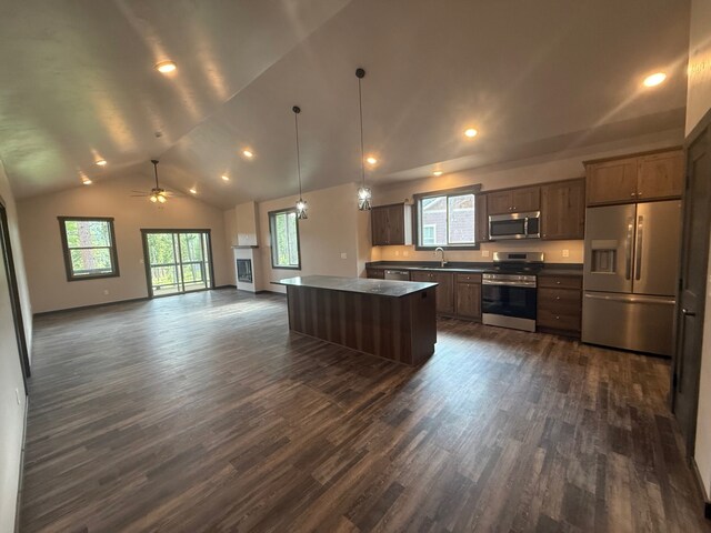 595 Grayling Rd, Lakeside, MT 59922 - kitchen featuring appliances with stainless steel finishes, a center island, dark wood-type flooring, open floor plan, and lofted ceiling