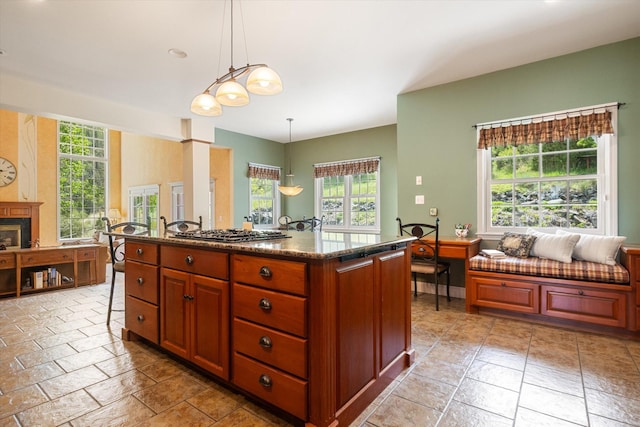 1 Reeders Village Dr, Helena, MT 59601 - kitchen featuring healthy amount of natural light, stone tile flooring, stainless steel gas stovetop, and decorative light fixtures