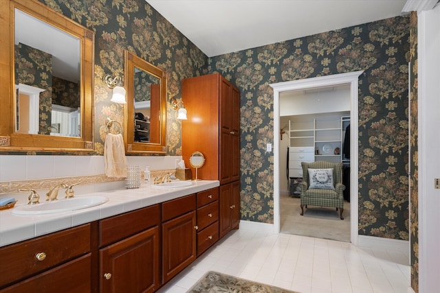 1 Reeders Village Dr, Helena, MT 59601 - full bath with baseboards, double vanity, tile patterned flooring, wallpapered walls, and a spacious closet