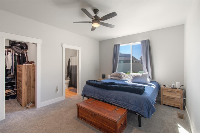259 Meadow View Loop, East Helena, MT 59635 - carpeted bedroom with a walk in closet, a closet, connected bathroom, baseboards, and ceiling fan