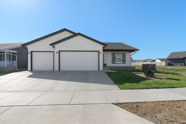 259 Meadow View Loop, East Helena, MT 59635 - ranch-style house with a garage, concrete driveway, and a front lawn