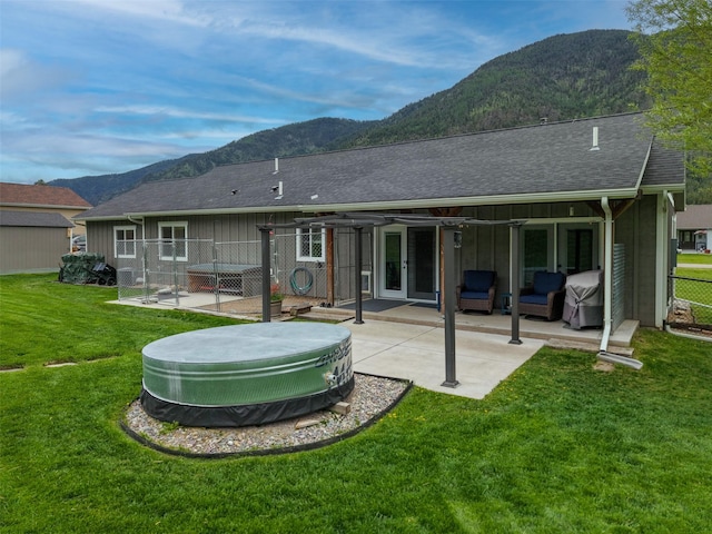 122 Bernie Rd, Alberton, MT 59820 - rear view of house with a mountain view, a patio, board and batten siding, and a shingled roof
