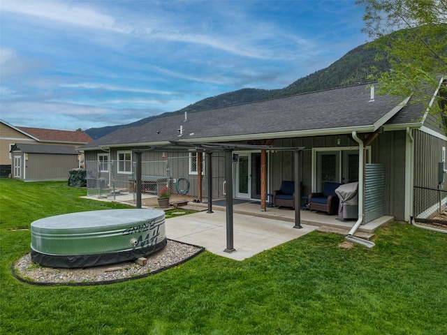 122 Bernie Rd, Alberton, MT 59820 - back of house featuring a mountain view, a patio, roof with shingles, an outdoor structure, and an outdoor living space