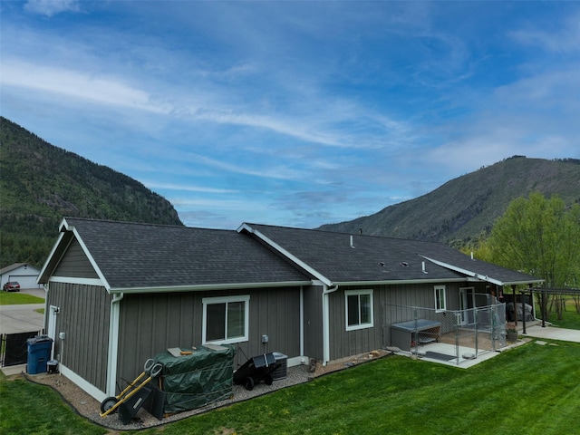 122 Bernie Rd, Alberton, MT 59820 - rear view of house featuring a mountain view, a patio, and roof with shingles