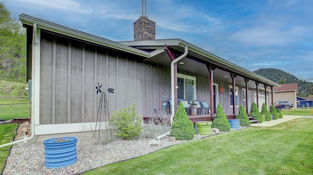 122 Bernie Rd, Alberton, MT 59820 - entrance to property featuring covered porch, a chimney, and board and batten siding