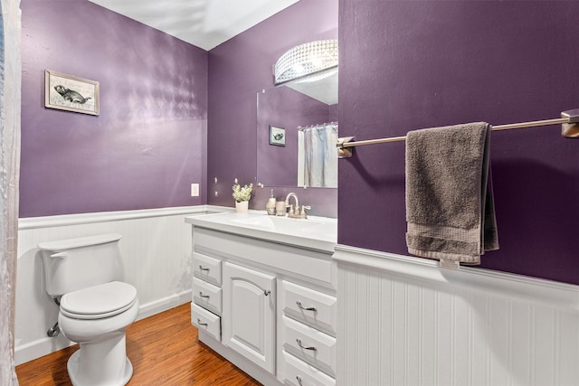 1861 E Broadway St, Missoula, MT 59802 - bathroom featuring vanity, wainscoting, toilet, and wood finished floors