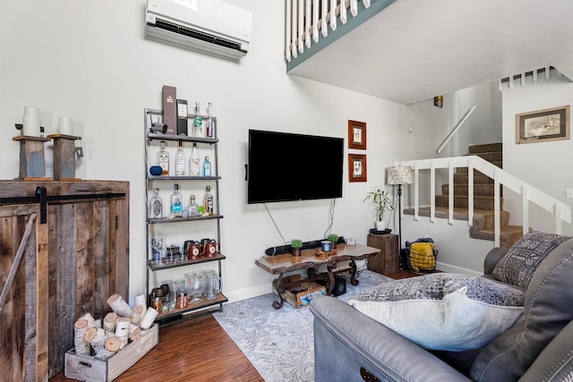 1861 E Broadway St, Missoula, MT 59802 - living area featuring a wall mounted air conditioner, wood finished floors, stairway, and baseboards