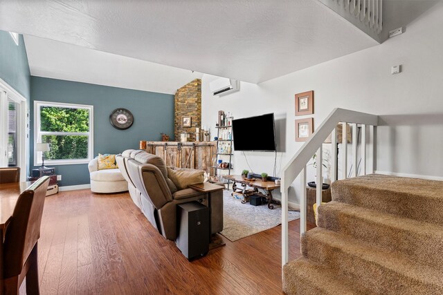 1861 E Broadway St, Missoula, MT 59802 - living room featuring stairs, wood finished floors, vaulted ceiling, baseboards, and a wall unit AC