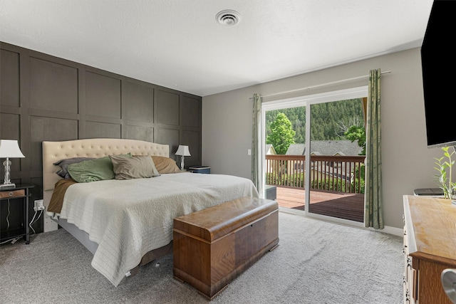 1861 E Broadway St, Missoula, MT 59802 - bedroom featuring a decorative wall, carpet floors, and access to outside