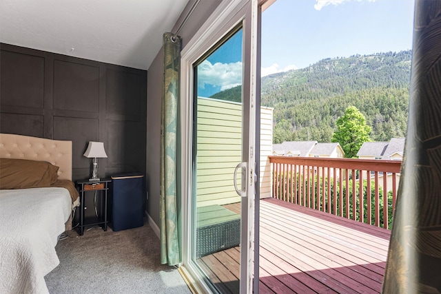 1861 E Broadway St, Missoula, MT 59802 - bedroom featuring a decorative wall, access to outside, a wooded view, and carpet floors
