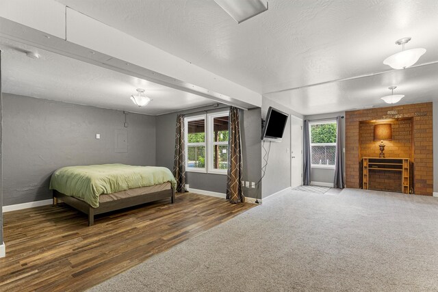 1861 E Broadway St, Missoula, MT 59802 - carpeted bedroom featuring baseboards, a textured ceiling, and wood finished floors