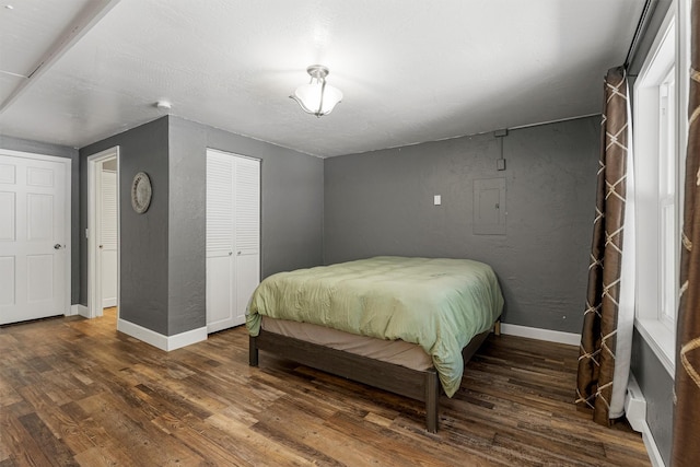 1861 E Broadway St, Missoula, MT 59802 - bedroom with wood finished floors, baseboards, a textured wall, a closet, and electric panel