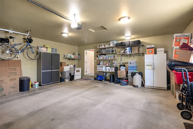 3717 Aster St, East Helena, MT 59635 - garage featuring white refrigerator with ice dispenser and a garage door opener