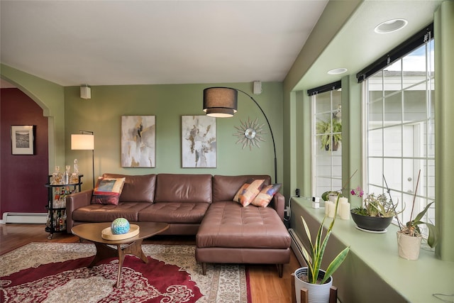 3717 Aster St, East Helena, MT 59635 - living area with a baseboard radiator, wood finished floors, and arched walkways